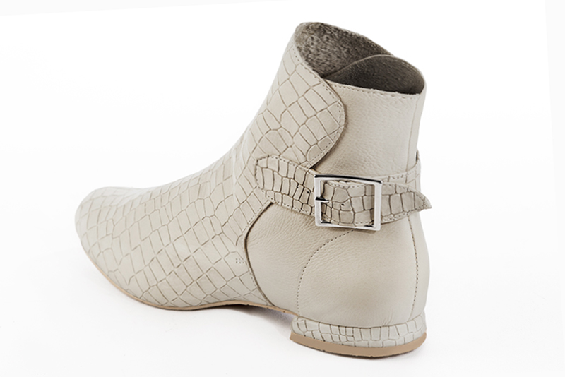 Off white women's ankle boots with buckles at the back. Round toe. Flat block heels. Rear view - Florence KOOIJMAN